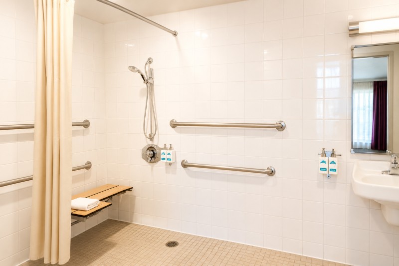 ADA accessible bathroom roll-in shower at Kings Inn Anaheim